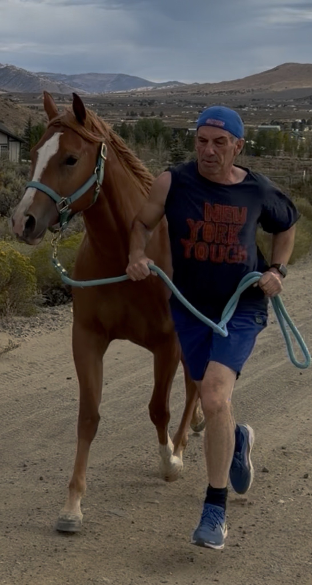 Jay and Essie moving together on a trail in the Reno hills